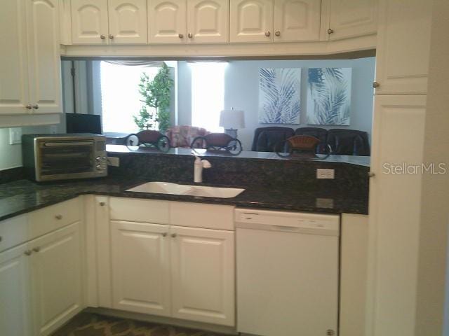 kitchen featuring a sink, white cabinets, and dishwasher