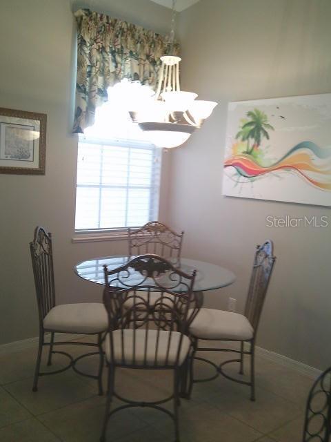 dining space featuring tile patterned flooring and baseboards