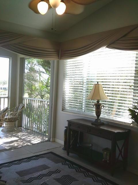 doorway featuring ceiling fan and baseboards