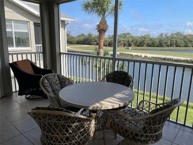 sunroom / solarium featuring a water view