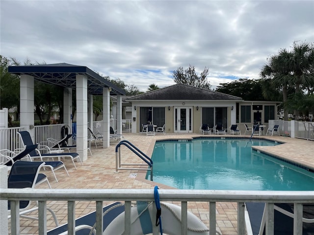 pool featuring a patio area and fence