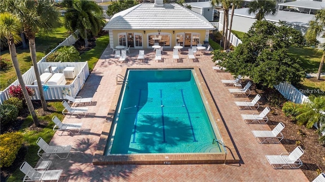 pool featuring a fenced backyard and a patio