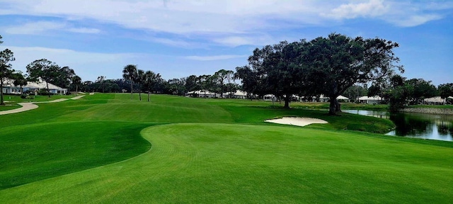 view of community featuring golf course view and a water view