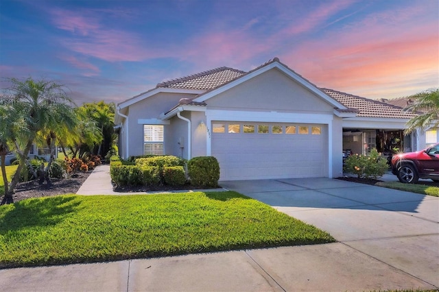 view of front of property featuring a garage and a yard