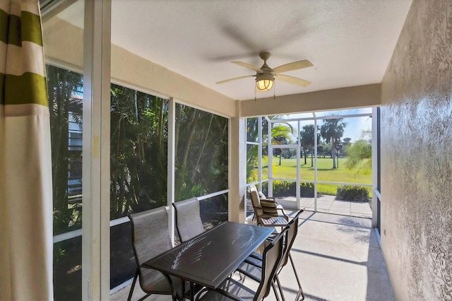 sunroom / solarium featuring ceiling fan