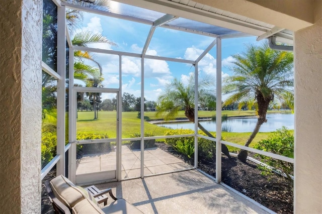 sunroom / solarium featuring a water view