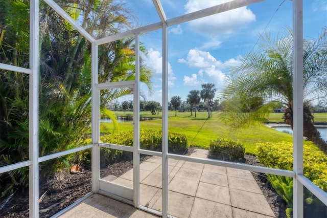 unfurnished sunroom with a wealth of natural light and a water view