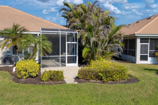 exterior space with a patio area, central AC, and a lawn