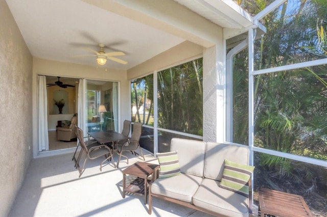 sunroom / solarium featuring ceiling fan