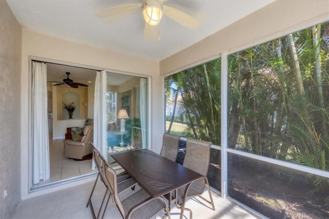 sunroom / solarium featuring ceiling fan