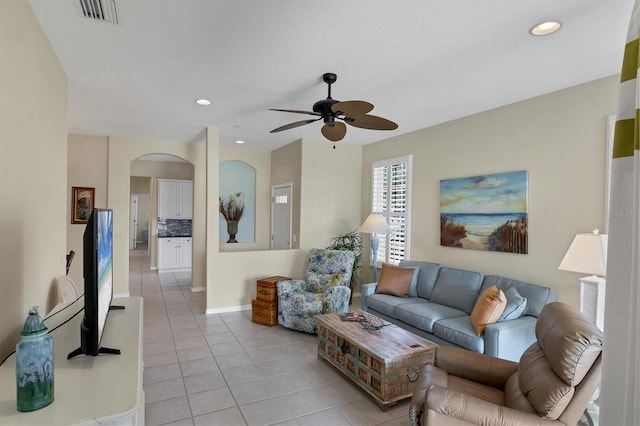 tiled living room with ceiling fan