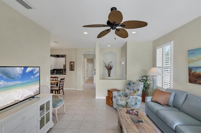 tiled living room featuring ceiling fan