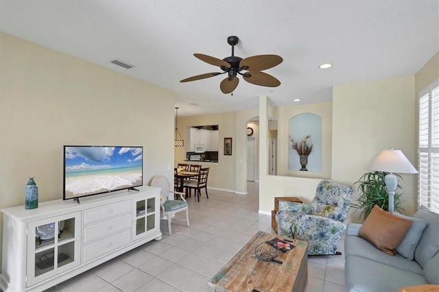 living room featuring ceiling fan and light tile patterned flooring