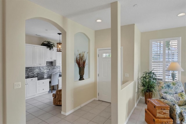 entryway with light tile patterned flooring