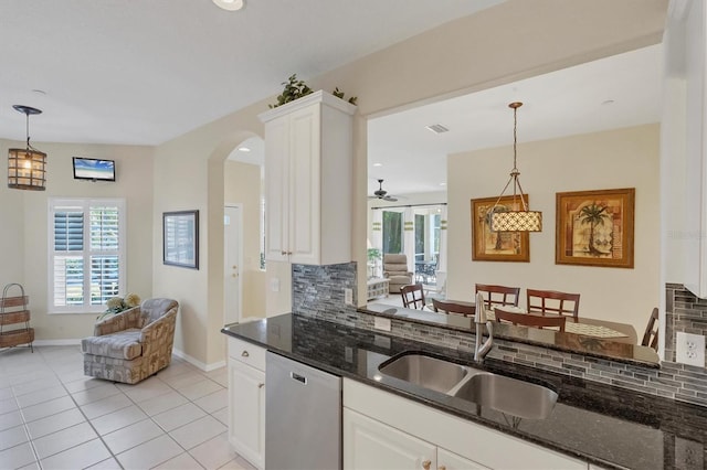 kitchen with white cabinets, stainless steel dishwasher, sink, and tasteful backsplash