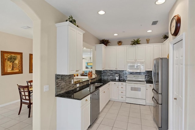 kitchen with sink, white cabinetry, light tile patterned floors, and stainless steel appliances