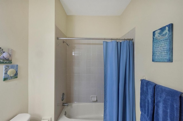 bathroom featuring toilet and shower / bath combo