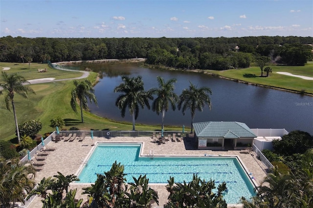 view of pool featuring a yard, a water view, and a patio