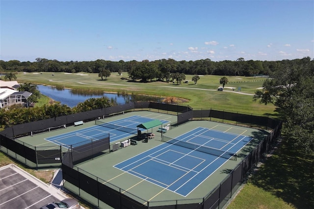 view of tennis court with a water view