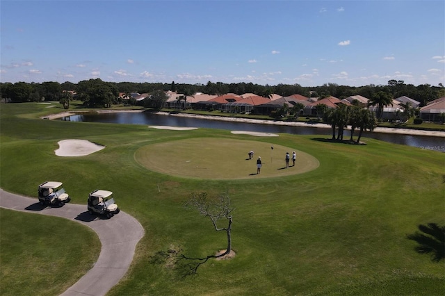 view of property's community featuring a water view and a lawn