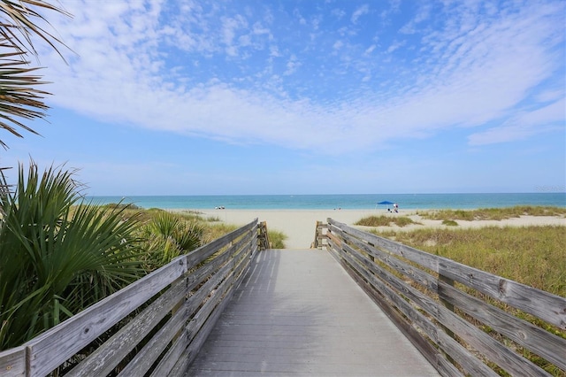 view of property's community with a beach view and a water view