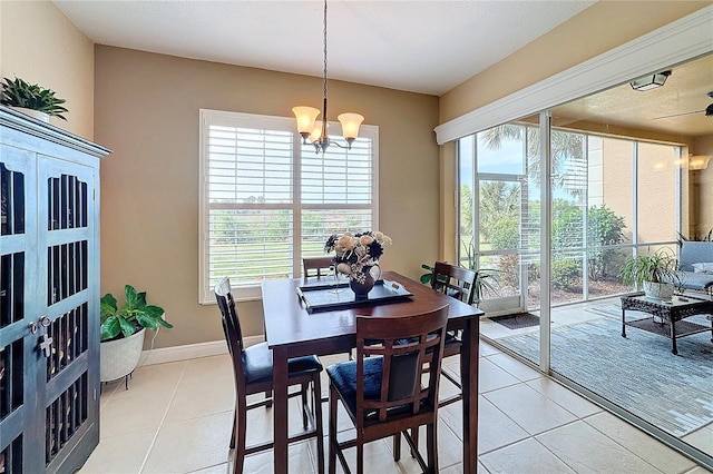 tiled dining space featuring a notable chandelier