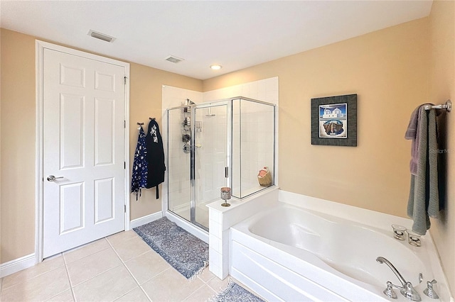 bathroom featuring tile patterned flooring and shower with separate bathtub