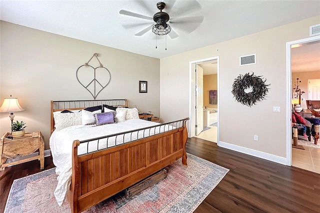 bedroom featuring ceiling fan, dark wood-type flooring, and ensuite bath