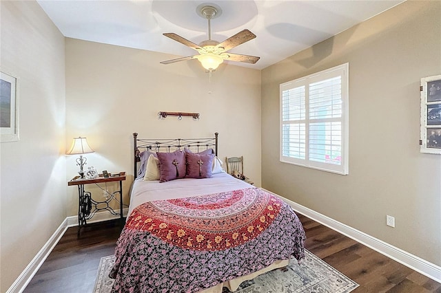 bedroom with ceiling fan and dark hardwood / wood-style floors