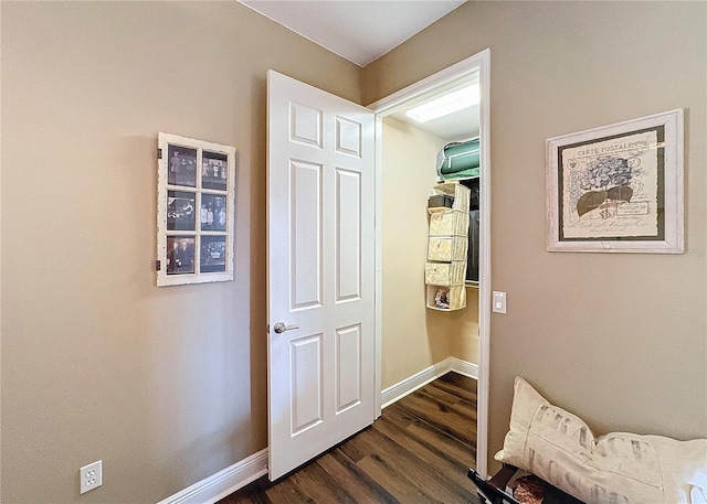 hallway with dark hardwood / wood-style flooring