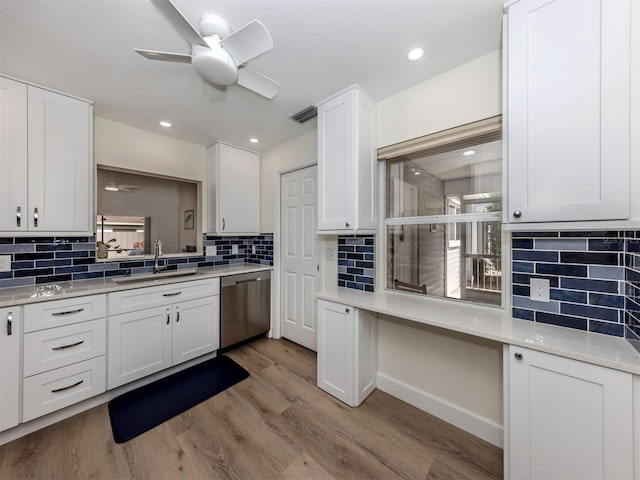 kitchen featuring sink, stainless steel dishwasher, white cabinets, and ceiling fan