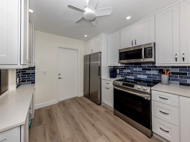 kitchen with white cabinets and appliances with stainless steel finishes