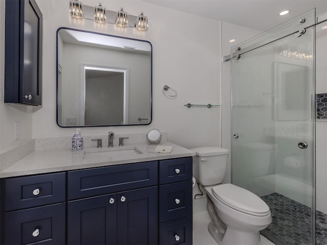 bathroom with toilet, an enclosed shower, and vanity