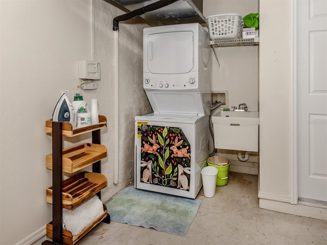 laundry area featuring sink and stacked washer / drying machine