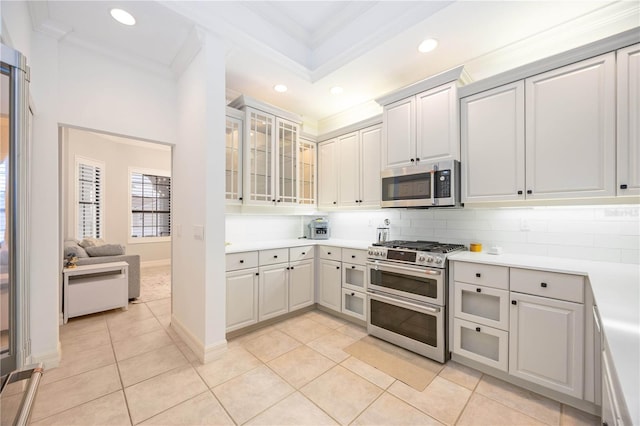 kitchen featuring tasteful backsplash, light tile patterned floors, appliances with stainless steel finishes, and crown molding