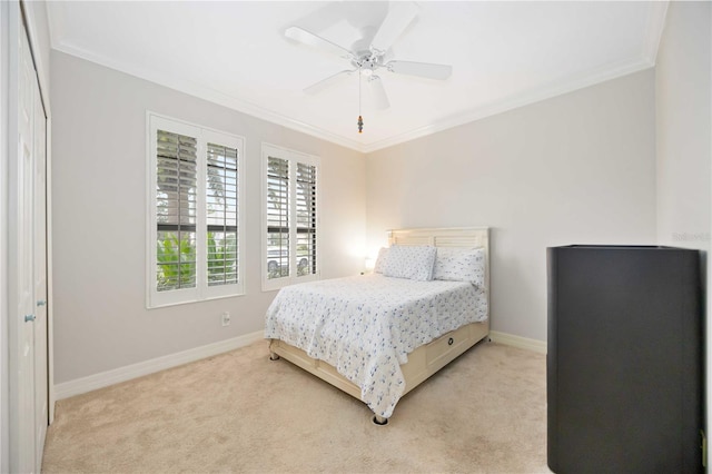 bedroom with ceiling fan, crown molding, and light carpet