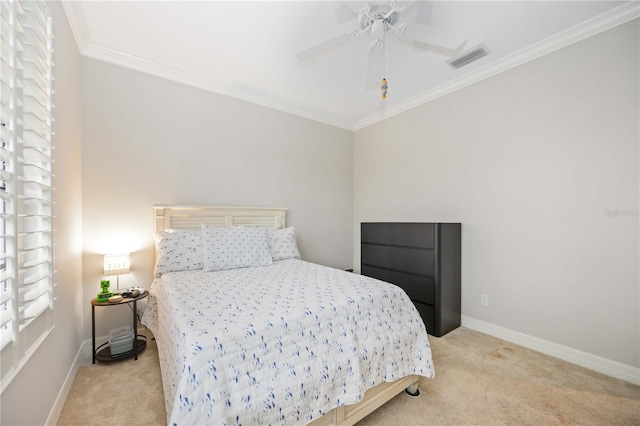 carpeted bedroom with ceiling fan and ornamental molding