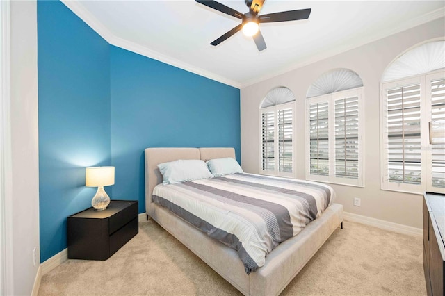 bedroom with light carpet, ceiling fan, and crown molding