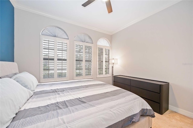 bedroom featuring light carpet, ceiling fan, and crown molding