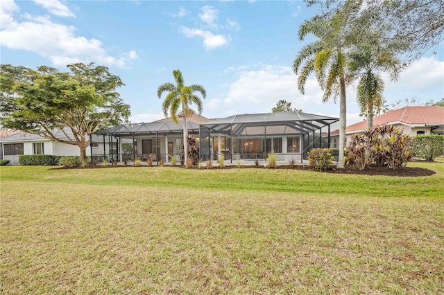 back of property with a lanai and a lawn