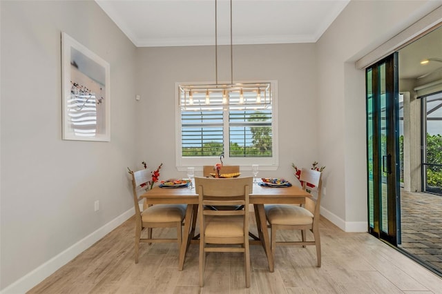 dining area featuring ornamental molding and light hardwood / wood-style flooring