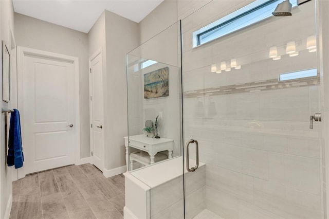 bathroom featuring a shower with door