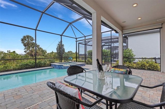 view of pool with an in ground hot tub, a patio area, and a lanai