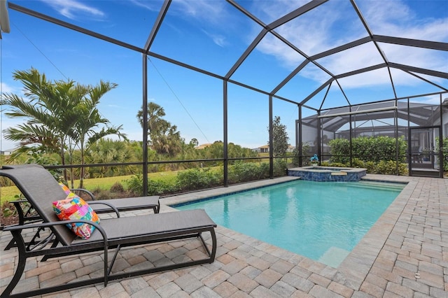 view of pool featuring an in ground hot tub, a patio area, and a lanai