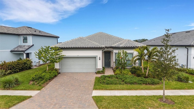 view of front of property featuring a garage and a front lawn