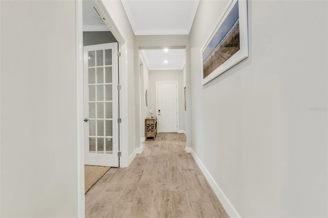 corridor with crown molding and light wood-type flooring