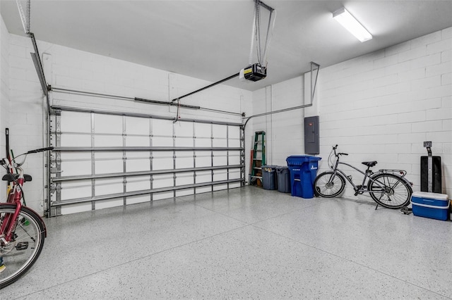 garage featuring electric panel and a garage door opener