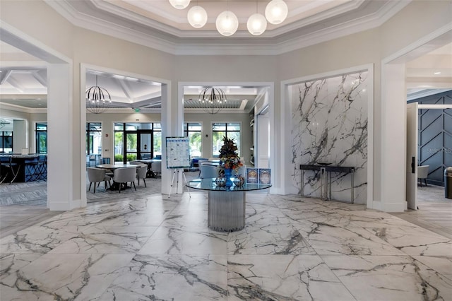 entryway featuring french doors, ornamental molding, and an inviting chandelier