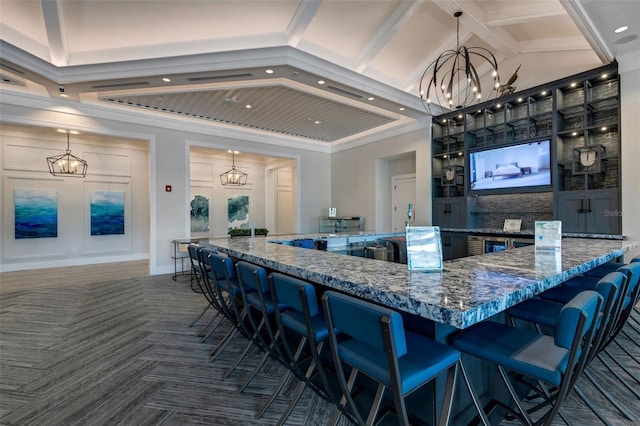 kitchen featuring decorative light fixtures, dark stone countertops, dark parquet floors, beam ceiling, and an inviting chandelier