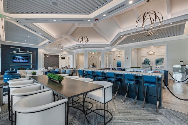 dining area with crown molding, a towering ceiling, and an inviting chandelier